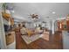 Spacious living area with a fireplace, wood floors, and an open layout leading to the dining area at 1732 Se 38Th Ct, Ocala, FL 34471