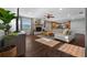 Open-concept living room with a fireplace, wood floors, and an adjacent kitchen at 1732 Se 38Th Ct, Ocala, FL 34471