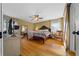 Cozy main bedroom with hardwood floors, a ceiling fan, and plenty of natural light at 1732 Se 38Th Ct, Ocala, FL 34471