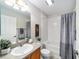 Clean bathroom featuring tile flooring, tub, and shower with gray curtains at 1854 Oxford Lane, The Villages, FL 32162