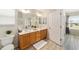 Bathroom featuring double vanity, large mirror, and stylish flooring at 1854 Oxford Lane, The Villages, FL 32162