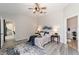 Beautifully staged bedroom with ceiling fan, stylish rug, and ample natural light at 1854 Oxford Lane, The Villages, FL 32162