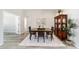 Classic dining room featuring a dark wooden dining set and neutral gray walls and decor at 1854 Oxford Lane, The Villages, FL 32162