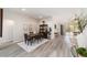 Open-concept dining room with wood floors, modern decor, and sliding doors to the outdoor patio at 1854 Oxford Lane, The Villages, FL 32162
