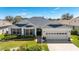 Charming home with well-manicured landscaping and a two-car garage at 1854 Oxford Lane, The Villages, FL 32162