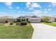 Inviting single-story home with blue shutters and a neatly landscaped front yard at 1854 Oxford Lane, The Villages, FL 32162