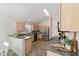 Bright kitchen featuring wooden cabinets, stainless steel appliances, and updated countertops at 1854 Oxford Lane, The Villages, FL 32162