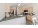Open kitchen with stainless steel appliances, wooden cabinets and breakfast bar at 1854 Oxford Lane, The Villages, FL 32162