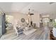 Spacious living room featuring wood floors, neutral tones, and a ceiling fan at 1854 Oxford Lane, The Villages, FL 32162