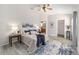 Calming main bedroom featuring a ceiling fan, luxury vinyl flooring and ensuite bath and walk-in closet at 1854 Oxford Lane, The Villages, FL 32162