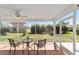 Enclosed porch features tiled floors and relaxing views of the lush backyard at 1854 Oxford Lane, The Villages, FL 32162