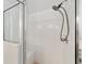 Shower stall featuring a glass door, shower head and a built-in bench at 1854 Oxford Lane, The Villages, FL 32162