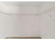 Empty walk-in closet with white walls and metal storage shelving, ready to be filled at 1854 Oxford Lane, The Villages, FL 32162