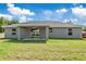 Backyard view of the home featuring a covered lanai at 2 Hemlock Ter Dr, Ocala, FL 34472