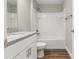 Bathroom featuring granite countertops, a white tiled shower, and modern fixtures at 2 Hemlock Ter Dr, Ocala, FL 34472