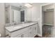 Bathroom featuring double sinks, granite countertops, tile floors, and a walk-in shower at 2 Hemlock Ter Dr, Ocala, FL 34472