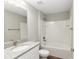 Bathroom featuring granite countertops, a white tiled shower, and modern fixtures at 2 Hemlock Ter Dr, Ocala, FL 34472