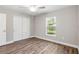 Bright bedroom featuring hardwood floors, a ceiling fan, and closet with sliding doors at 2 Hemlock Ter Dr, Ocala, FL 34472