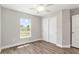 Bright bedroom featuring hardwood floors, a ceiling fan, closet and a sunlit window at 2 Hemlock Ter Dr, Ocala, FL 34472