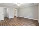Bedroom with wood floors, a ceiling fan, and an ensuite bathroom and walk-in closet at 2 Hemlock Ter Dr, Ocala, FL 34472