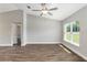 Spacious bedroom with wood floors, a ceiling fan, and a large window providing natural light at 2 Hemlock Ter Dr, Ocala, FL 34472