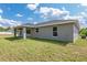 Rear exterior view of the home showing covered lanai and backyard at 2 Hemlock Ter Dr, Ocala, FL 34472
