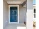 Close-up of a stylish blue front door with glass accents and a modern gray exterior at 2 Hemlock Ter Dr, Ocala, FL 34472