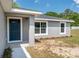 A home's front entrance, featuring a blue front door and modern gray exterior at 2 Hemlock Ter Dr, Ocala, FL 34472