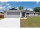 Charming front exterior of the home featuring a well-manicured lawn at 2 Hemlock Ter Dr, Ocala, FL 34472