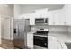 Stainless steel appliances and granite countertops, adding a touch of elegance to the kitchen at 2 Hemlock Ter Dr, Ocala, FL 34472