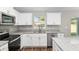 Close-up of the updated kitchen, showcasing granite countertops and stainless steel appliances at 2 Hemlock Ter Dr, Ocala, FL 34472