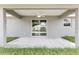 Covered lanai with concrete deck, ceiling fan, and sliding glass doors to the home's interior at 2 Hemlock Ter Dr, Ocala, FL 34472