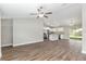 Open-concept living area featuring wood floors, a ceiling fan, and a combined kitchen-living space at 2 Hemlock Ter Dr, Ocala, FL 34472