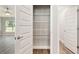 Bright pantry with wire shelving, located off of a room with wood floors and a ceiling fan at 2 Hemlock Ter Dr, Ocala, FL 34472