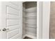 Bright pantry with wire shelving, located off of a bathroom with a tile shower at 2 Hemlock Ter Dr, Ocala, FL 34472