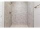 Walk-in shower featuring tile walls and floors, and a shower head at 2 Hemlock Ter Dr, Ocala, FL 34472