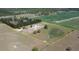 An aerial view of a property with a large open field, treeline, residence, and a yellow boundary line at 2061 Nw 165Th Court Rd, Dunnellon, FL 34432