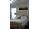 Cozy bedroom featuring a decorative headboard with a comfortable bed, a window, and a mini refrigerator at 2061 Nw 165Th Court Rd, Dunnellon, FL 34432