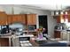 Open dining room with a rustic table, pendant lighting, and kitchen access, perfect for gatherings and modern living at 2061 Nw 165Th Court Rd, Dunnellon, FL 34432