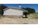 Charming home featuring stone accents, a metal roof, and a well-maintained landscaped yard at 2061 Nw 165Th Court Rd, Dunnellon, FL 34432