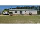 Charming home featuring stone accents, a metal roof, and a well-maintained landscaped yard at 2061 Nw 165Th Court Rd, Dunnellon, FL 34432
