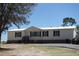 A single-Gathering home with a well-maintained exterior and a metal roof in a rural setting at 2061 Nw 165Th Court Rd, Dunnellon, FL 34432