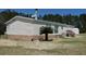 Charming home featuring stone accents, a metal roof, and a well-maintained landscaped yard at 2061 Nw 165Th Court Rd, Dunnellon, FL 34432