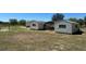Exterior view of multiple sheds and a tractor shed with a lawn at 2061 Nw 165Th Court Rd, Dunnellon, FL 34432