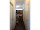 Hallway featuring wood flooring and white trim, connecting various rooms for easy access at 2061 Nw 165Th Court Rd, Dunnellon, FL 34432