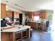 Open-concept kitchen with an eat-in island, lots of cabinets, and dark hardwood floors at 2061 Nw 165Th Court Rd, Dunnellon, FL 34432
