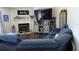 Comfortable living room area with a fire place and entertainment center with soft, blue furniture at 2061 Nw 165Th Court Rd, Dunnellon, FL 34432