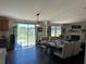 Open plan living room with an electric fireplace, hardwood floors, and access to backyard at 2061 Nw 165Th Court Rd, Dunnellon, FL 34432