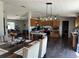 Open-concept space with wood floors connects the dining and kitchen areas, blending modern style with functionality at 2061 Nw 165Th Court Rd, Dunnellon, FL 34432