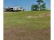 Expansive green land featuring a residence and parked RV, ideal for rural living and outdoor at 2061 Nw 165Th Court Rd, Dunnellon, FL 34432